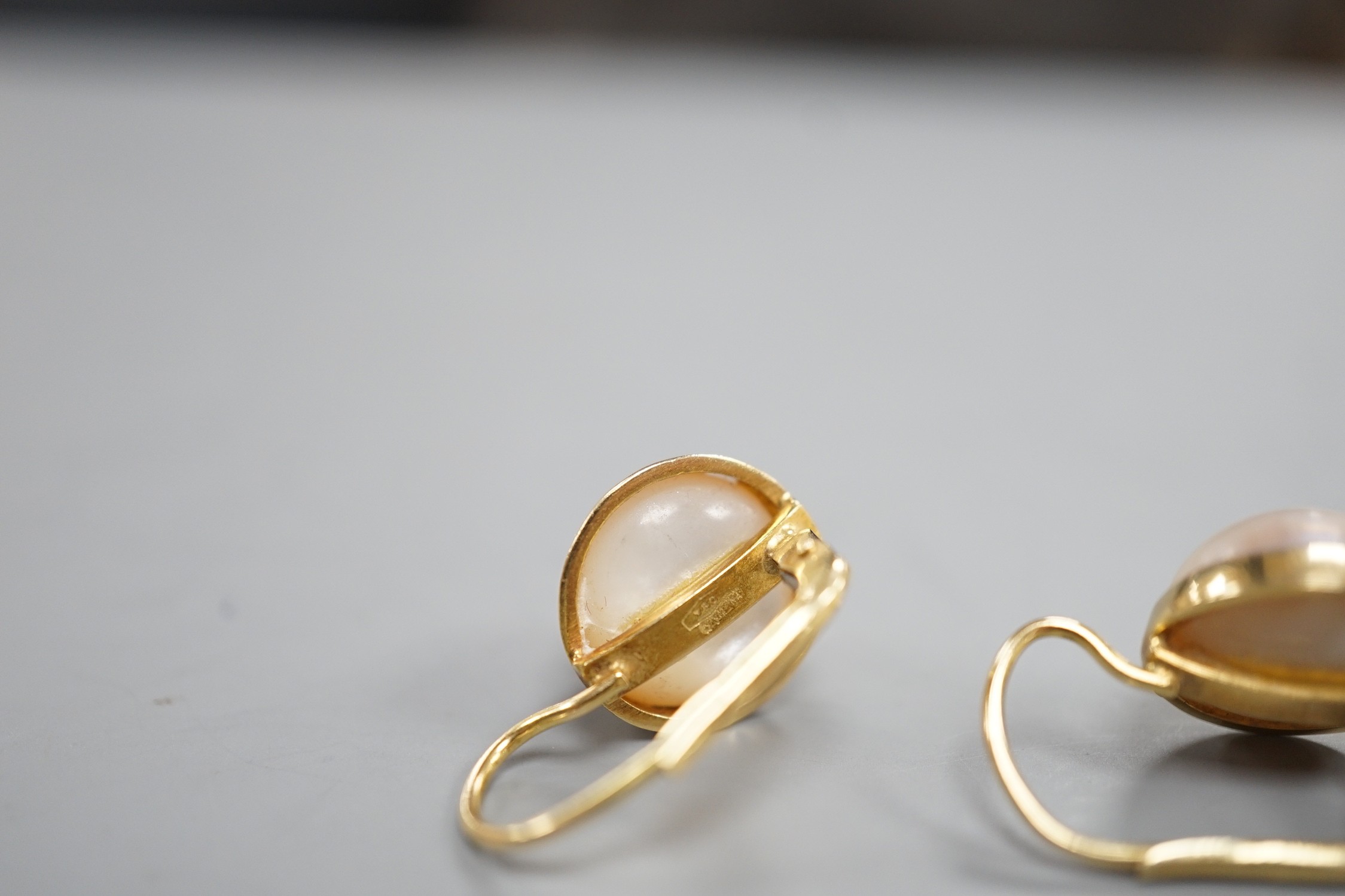 A modern pair of Italian 750 yellow metal and mabe pearl set earrings, diameter 11mm, gross weight 6.4 grams.